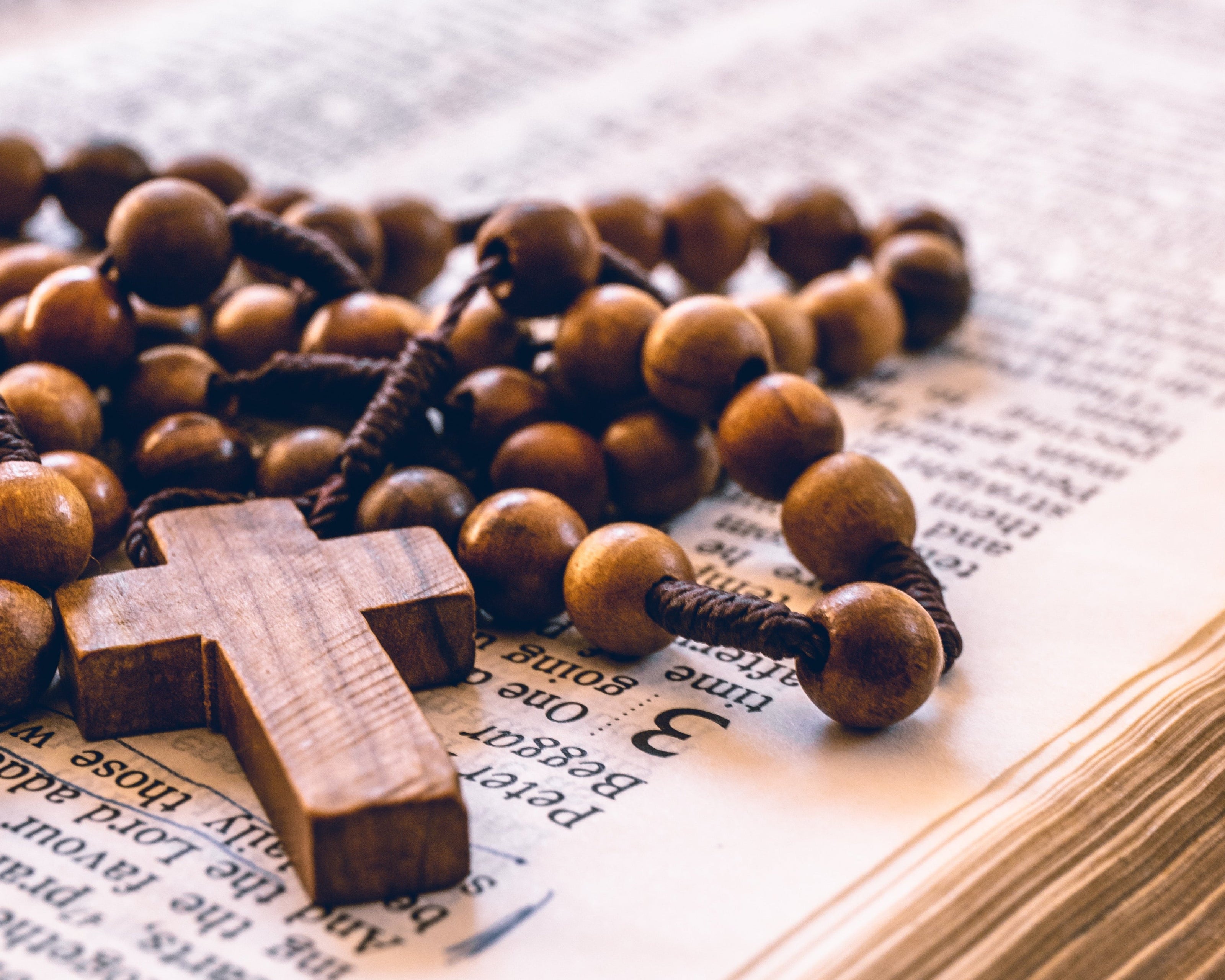 Wooden rosary on a bible